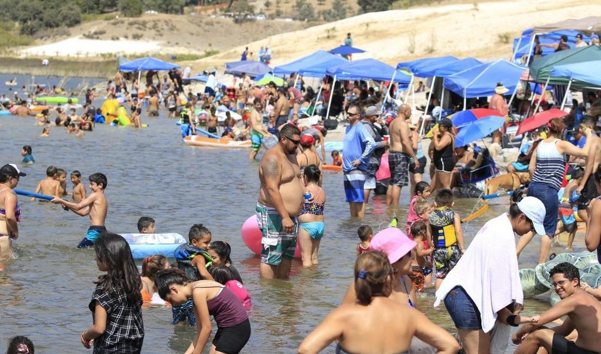 Campers and visitors at Lake Lopez in rural Arroyo Grande enjoy the cool water and a little breeze to stave off the summer SLO County heat.