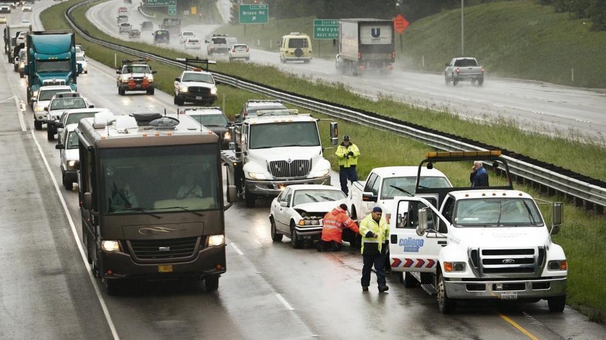 Crews with College Towing work to remove a BMW, a Ford pickup and a Honda that were involved in a collision Thursday morning on southbound Highway 101 at Grand Avenue in Arroyo Grande.