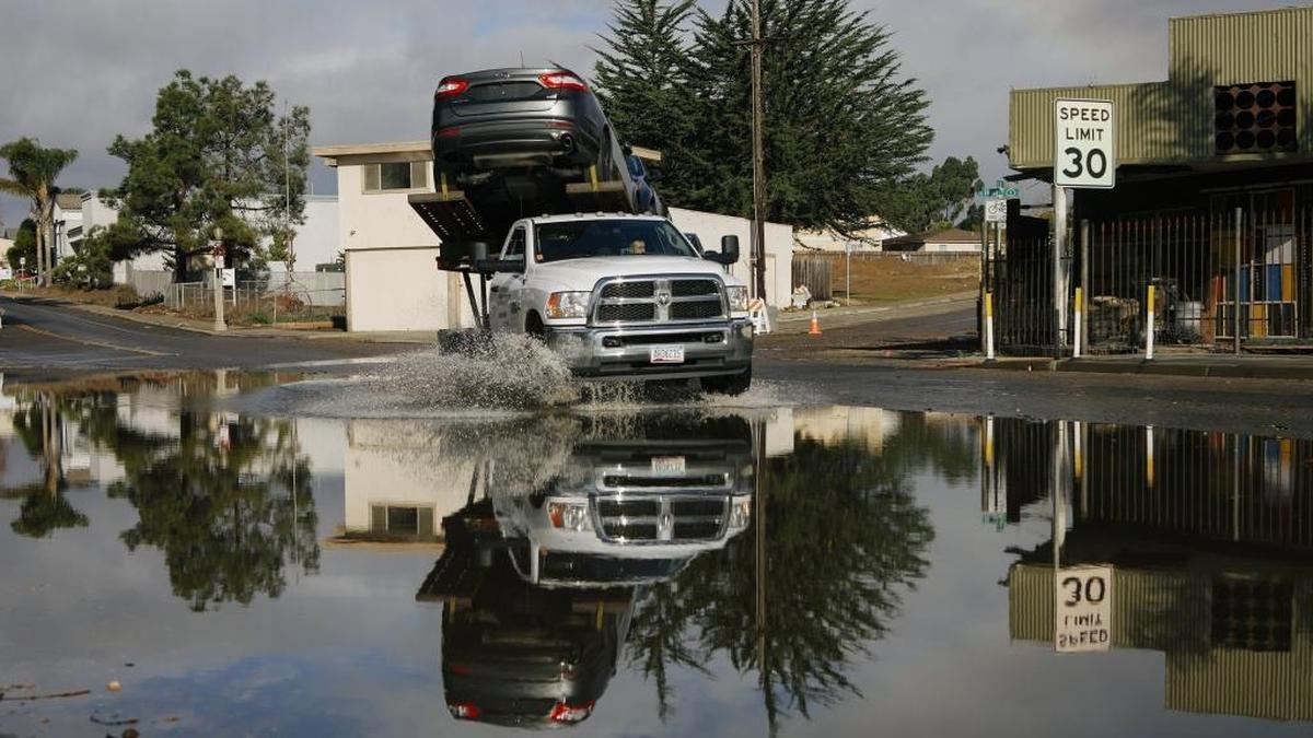 A truck drives through a flooded area of Highway 1 at 13th Street in Oceano in January. The road was closed Wednesday morningafter heavy rainfall.