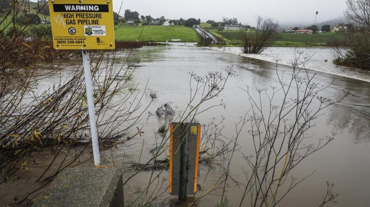 San Luis Creek flows over San Luis Bay Drive on Monday.