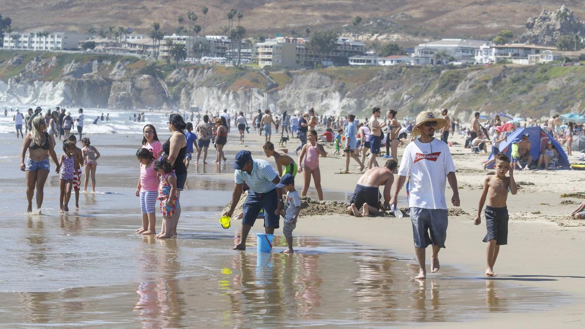 Crowds flocked to Pismo Beach on Friday as hot weather swept the region.