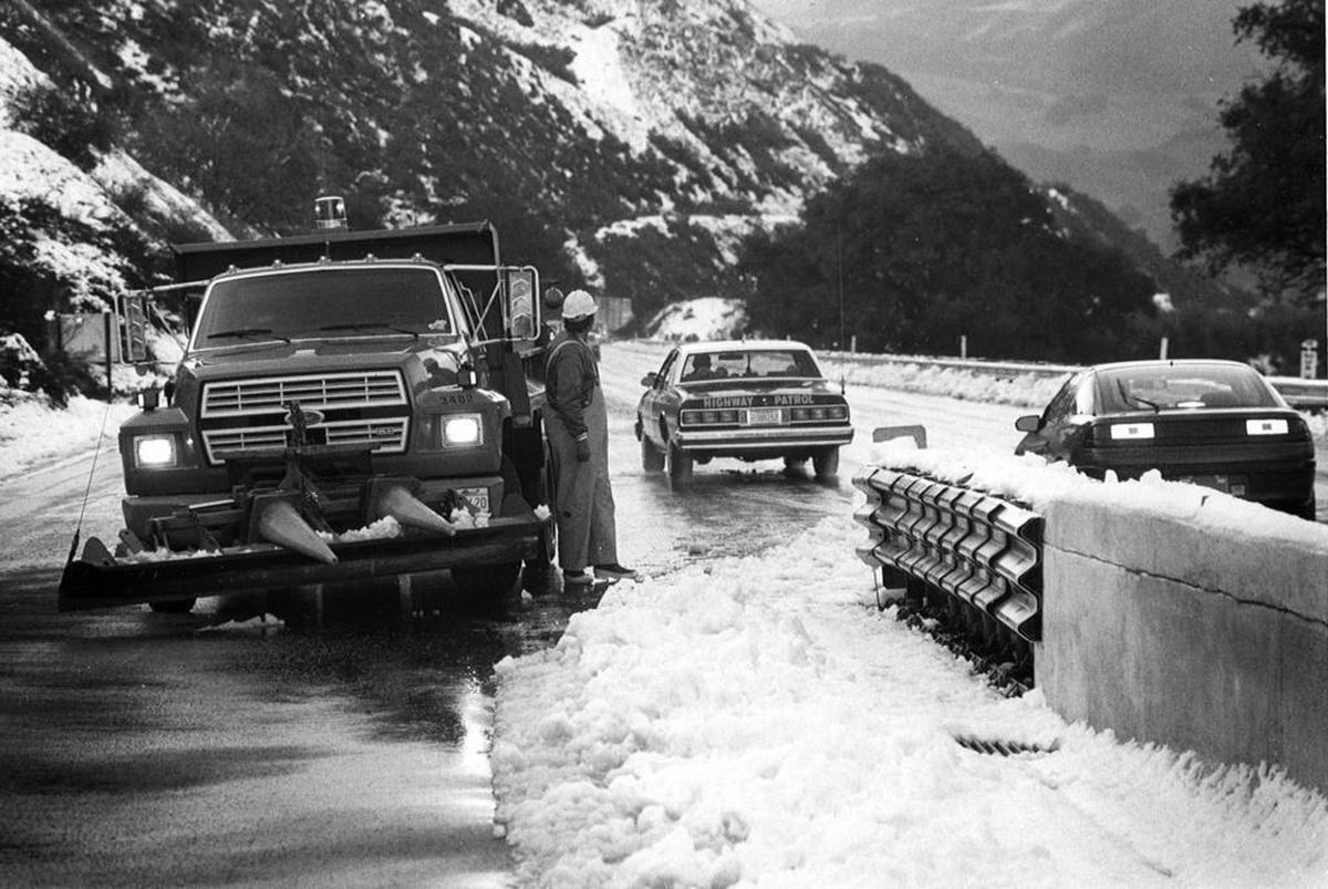 A CHP car escorts some of the first cars over a snowy Cuesta Grade about 6:45 a.m. March 19, 1991. The road had been closed due to snow and ice.