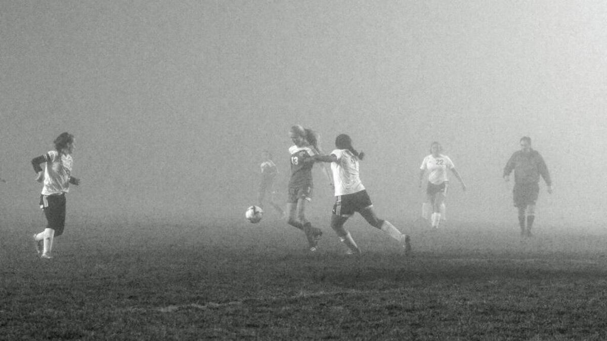Chloe Lindsey, No. 13, plays soccer in the fog a few years ago in this photo provided by the columnist. Areas of dense fog with mist this week will reduce driver visibility and may produce slippery road conditions.