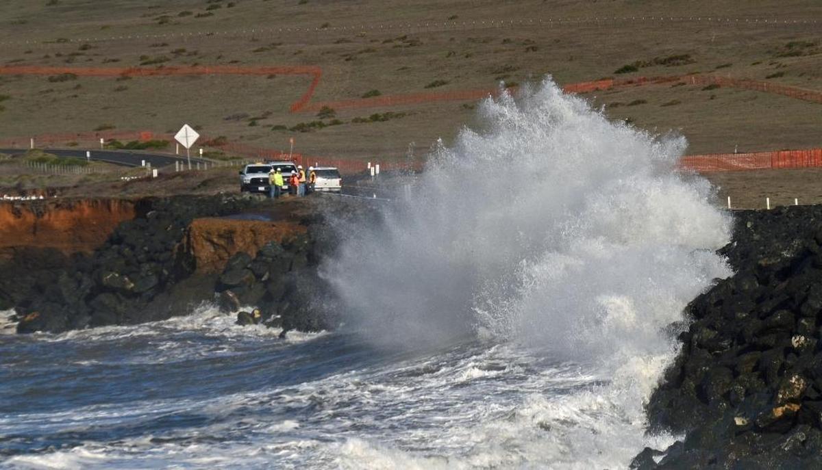 Waves splash on Highway 1 just north of Piedras Blancas Lighthouse during a king tide in 2015. 