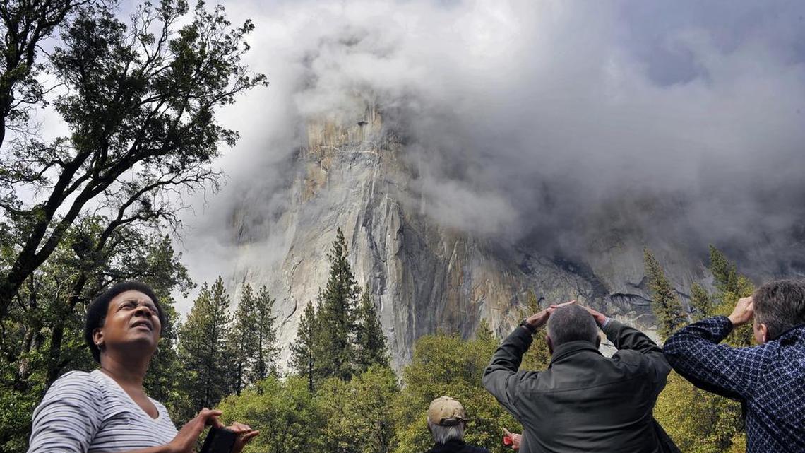 Visitors to California’s Yosemite Valley look toward clouds forming around El Capitan after a rainstorm following the celebration for the 125th Anniversary of Yosemite National Park in October.