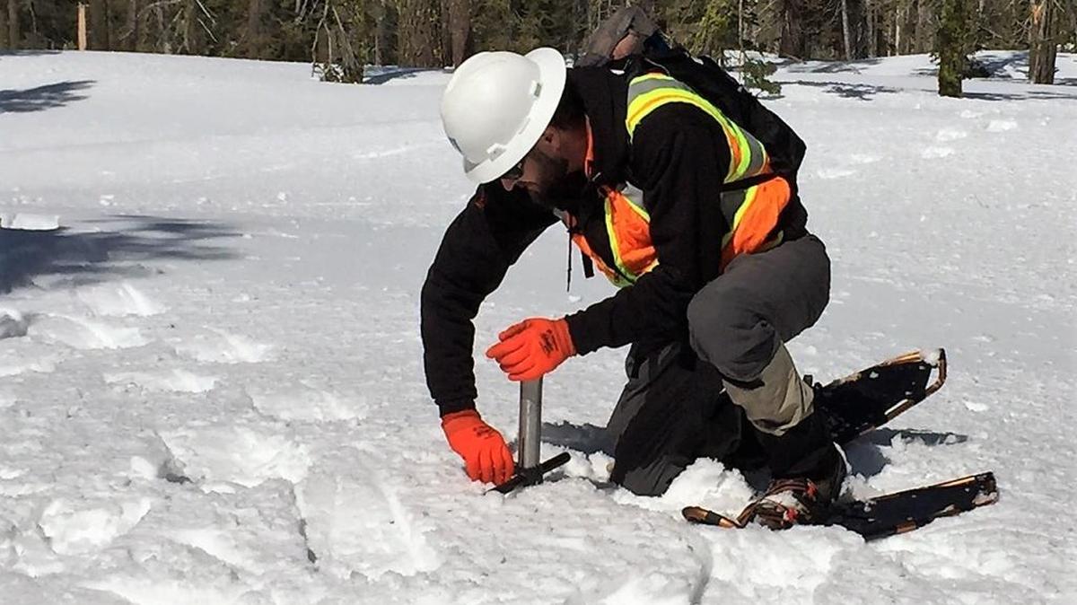 PG&E hydrographer Dan Stephens measures snow atop Dyer Mountain in Lassen County on Friday, March 31, 2017.