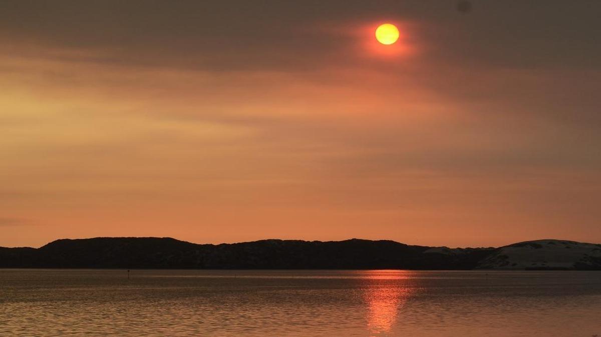 Smoke from the Chimney and Rey fires created an orange-reddish sunset at Baywood Park in Los Osos on Friday evening.