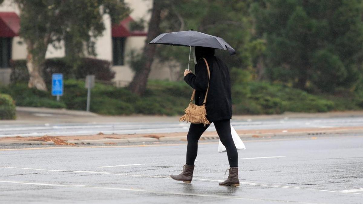 A woman crosses the intersection of Foothill Road and Santa Rosa in the rain last month.