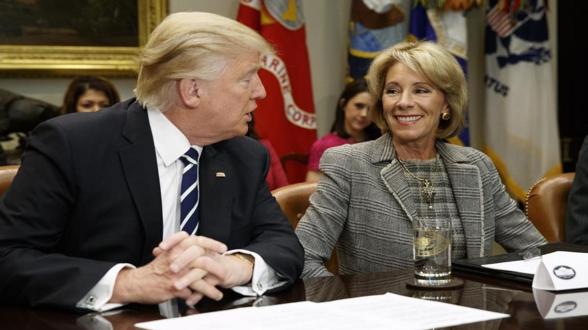 President Donald Trump looks at Education Secretary Betsy DeVos as he speaks during a meeting with parents and teachers, Tuesday, Feb. 14, 2017, in the Roosevelt Room of the White House in Washington.