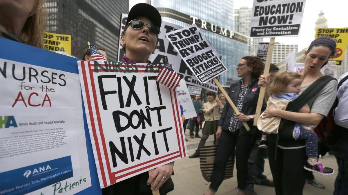 Protesters gather across the Chicago River from Trump Tower to rally against the repeal of the Affordable Care Act Friday, March 24, 2017, in Chicago.