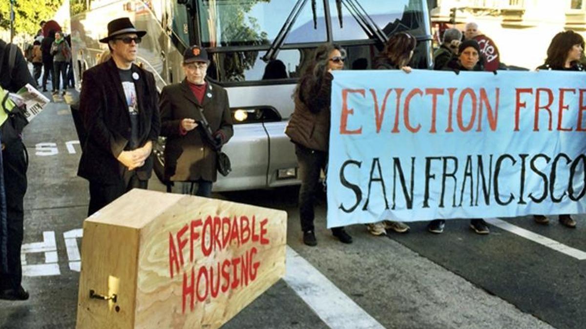 In this Dec. 20, 2013, file photo, anti-gentrification protesters temporarily block a shuttle bus full of tech workers at a Mission District public bus stop in San Francisco.