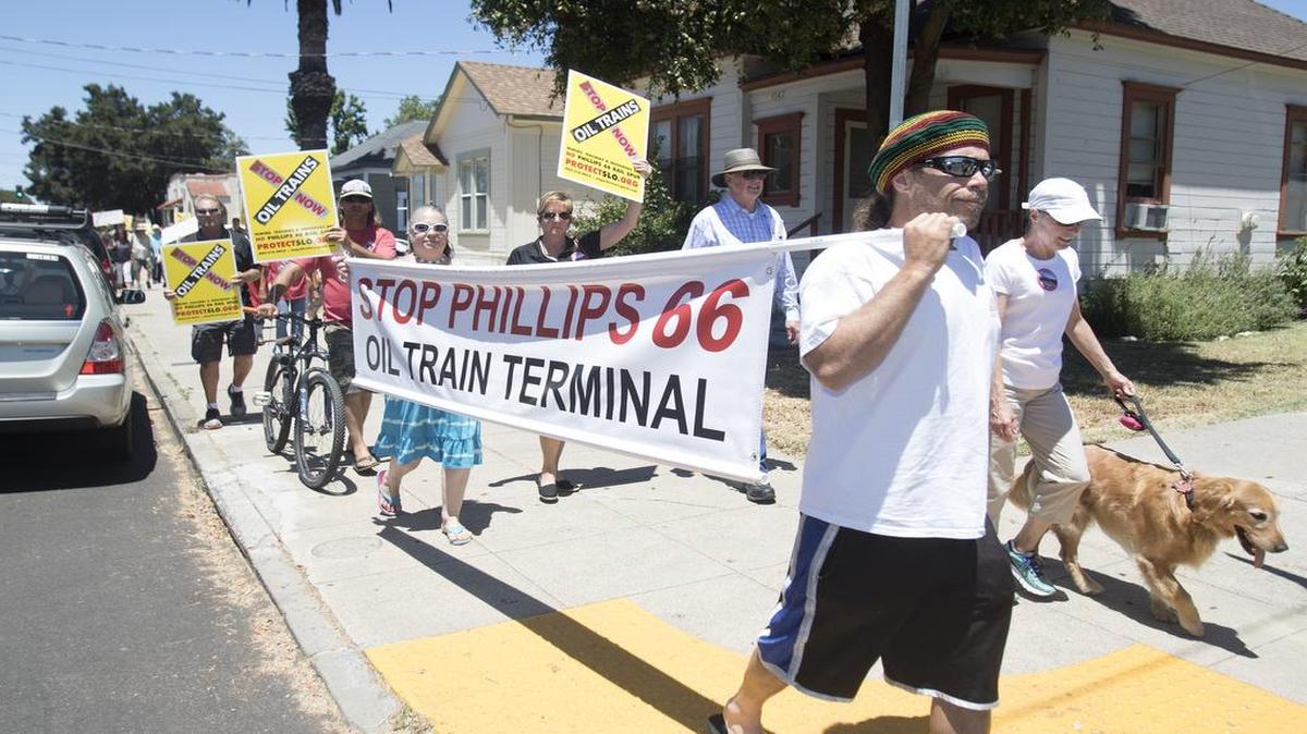 A protest against the approval of oil trains coming through San Luis Obispo County was held at Mitchell Park in San Luis Obispo in July 2016. Protesters march with signs down Santa Barbara Street in San Luis Obispo toward the Amtrak train station.