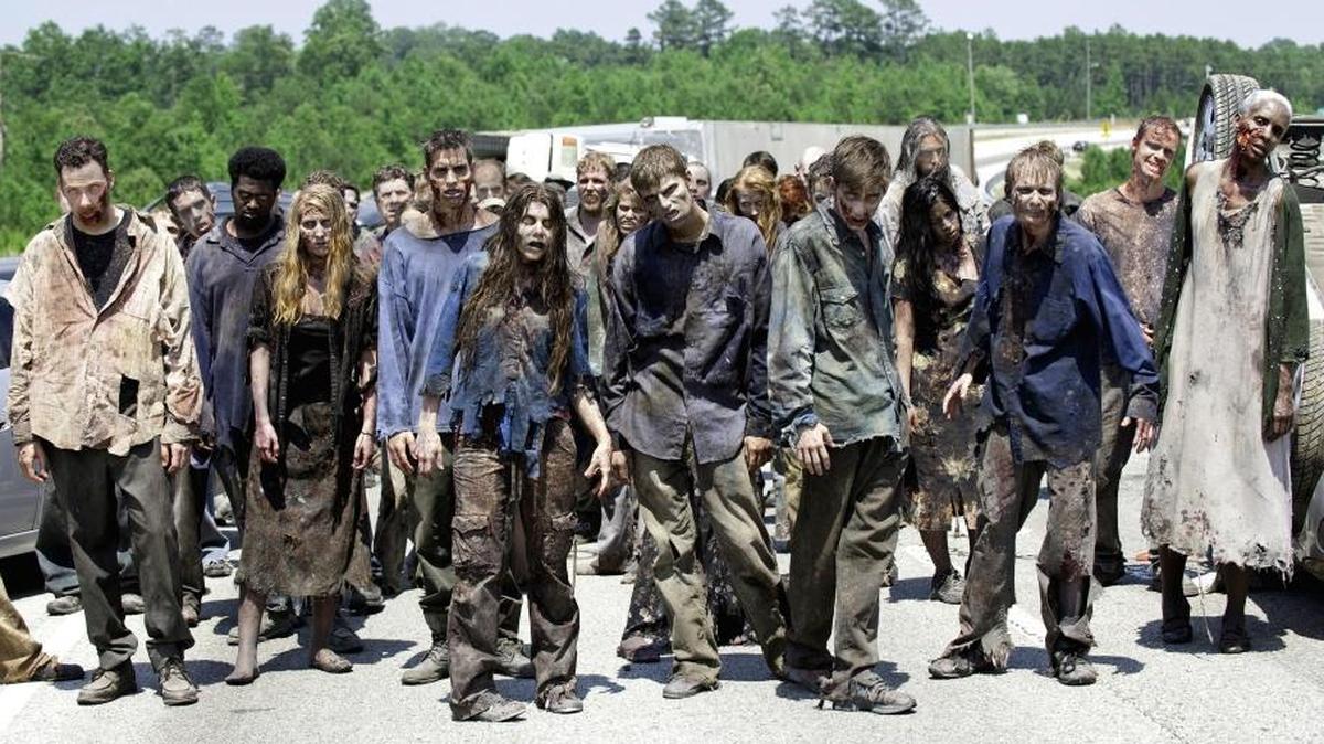 In this image released by AMC, zombies appear in a scene from the second season of the AMC original series, “The Walking Dead,” in Senoia, Georgia.
