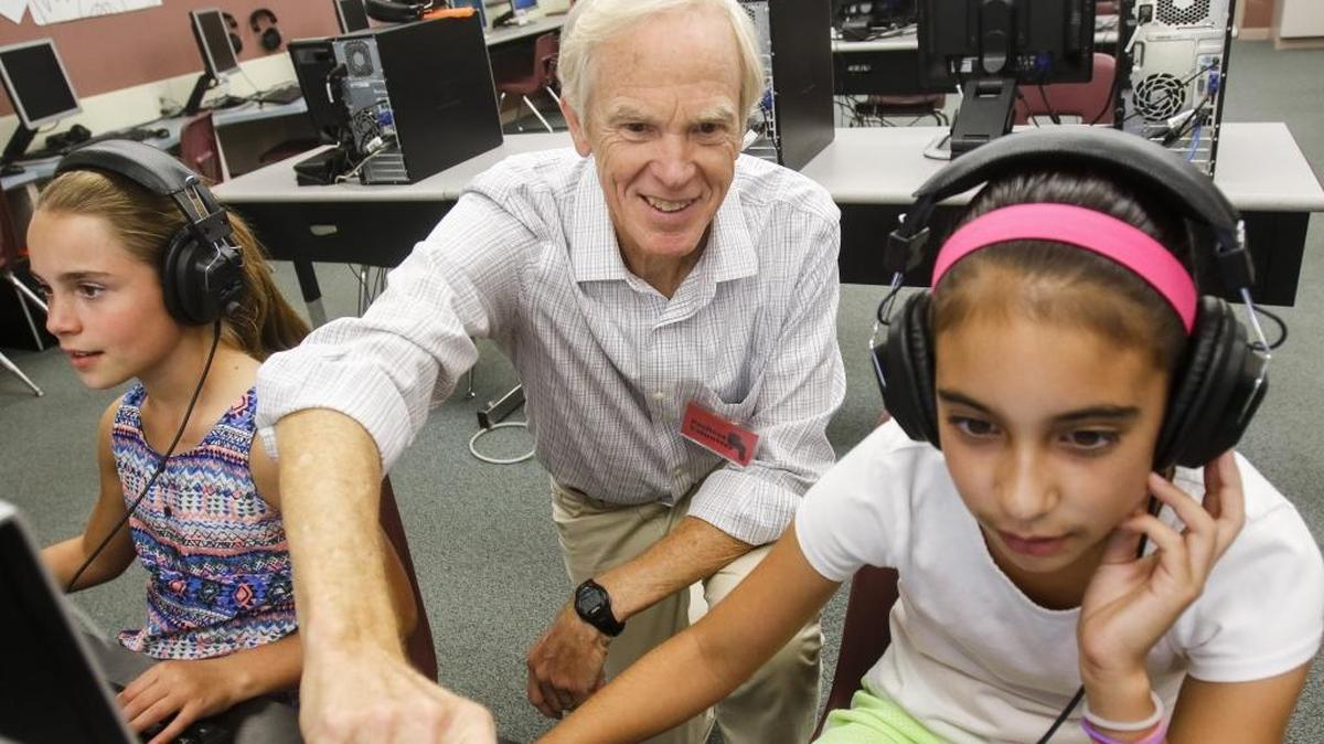 Jim Verhulst, a volunteer at Pacheco Elementary School in San Luis Obispo, started an after-school computer programming class available through Google. Here, Verhulst helps Samantha Rivera, 11, while Tairyn Barket, 10, left, works on her project.