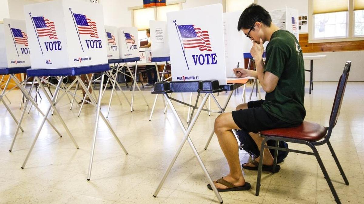 In this 2016 file photo, Christopher Chun casts his vote at the polls at the Zion Lutheran Church in San Luis Obispo.