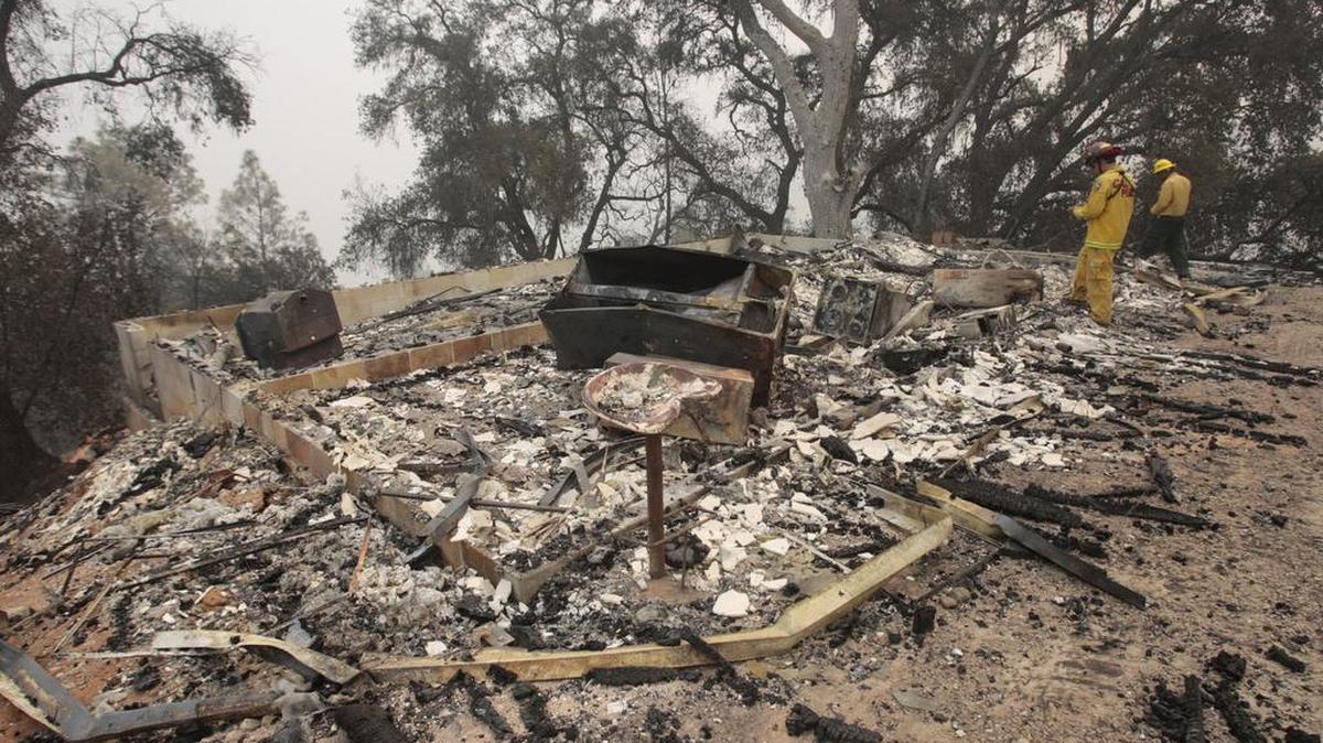 Cal Fire’s Gene Potkey, left, and Macho Rosa with the U.S. Forest Service conduct damage inspection at Cal Shasta.