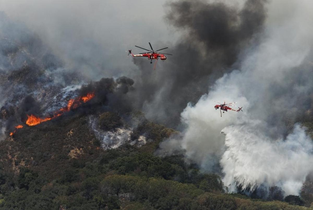 Helicopters drop water on the southwestern front of the Chimney Fire.