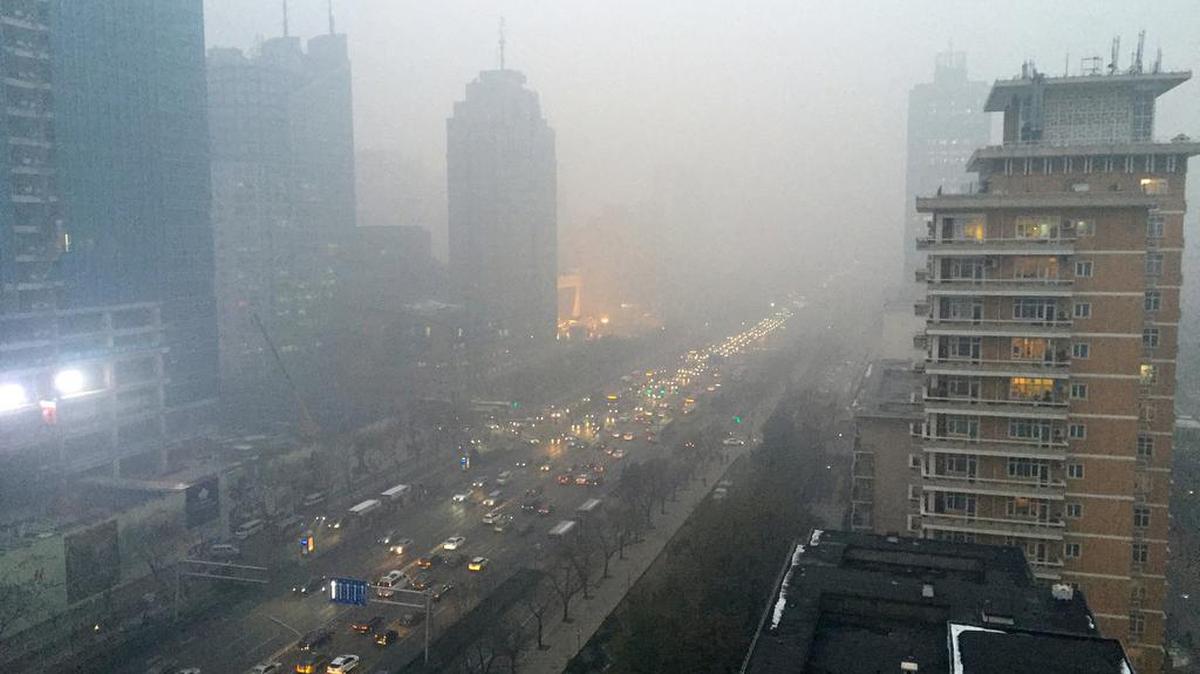 Smog hangs over Beijing’s main boulevard, Chang’an Avenue, looking west toward the Forbidden City, Nov. 30. Although the city is cracking down on dirty vehicles and some power plants, smog still frequently hangs over the city. Chinese President Xi Jinping went to climate talks in Paris earlier this month to pledge that China will reduce emissions linked to global climate change.