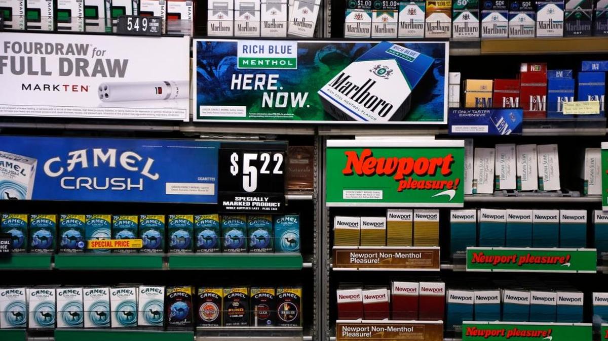 FILE - In this Friday, July 17, 2015 file photo, Camel and Newport cigarettes, both Reynolds American brands, are on display at a Smoker Friendly shop in Pittsburgh.