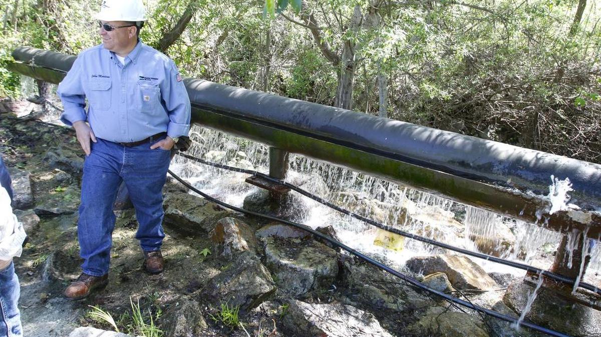 John Martini, director of governmental affairs with Freeport-McMoRan, which owns Price Canyon oil field, stands next to water that is released into Pismo Creek after being purified. The oil field purifies some of the wastewater from drilling and injects the rest back into the ground.