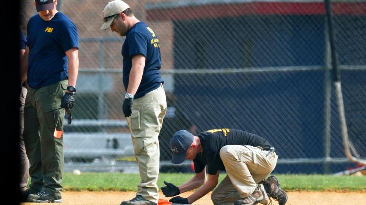 A FBI Evidence Response Team marks evidence on the ball field which is the scene of a multiple shooting in Alexandria, Va., Wednesday, June 14, 2017, after a rifle-wielding attacker opened fire on Republican lawmakers at a congressional baseball practice, wounding House GOP Whip Steve Scalise of Louisiana and several others as congressmen and aides dove for cover.