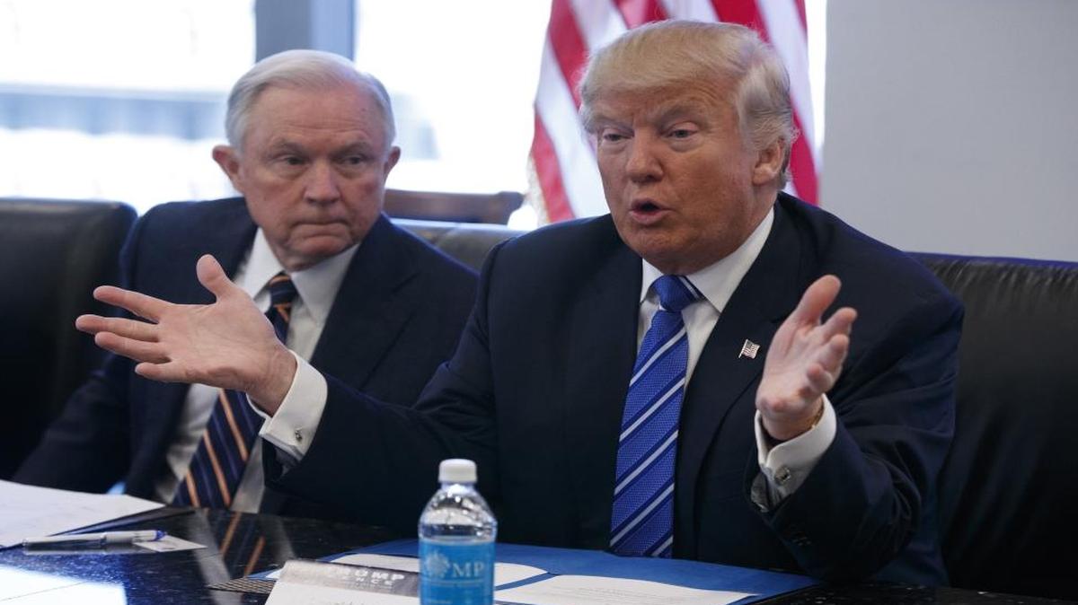 In this Oct. 7, 2016 file photo, Sen. Jeff Sessions, R-Ala. listens at left as then-Republican presidential candidate Donald Trump speaks during a national security meeting with advisers at Trump Tower in New York.