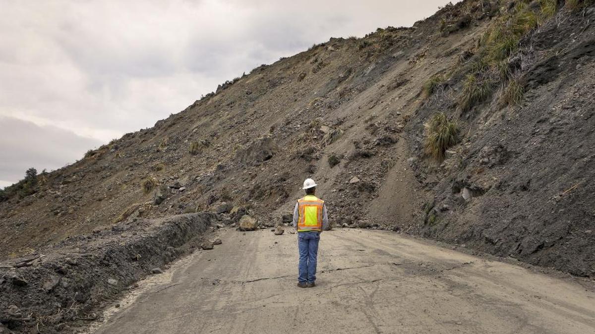 Bret Haney, construction inspector with Caltrans, looks at the south side of the Mud Creek Slide on Highway 1.