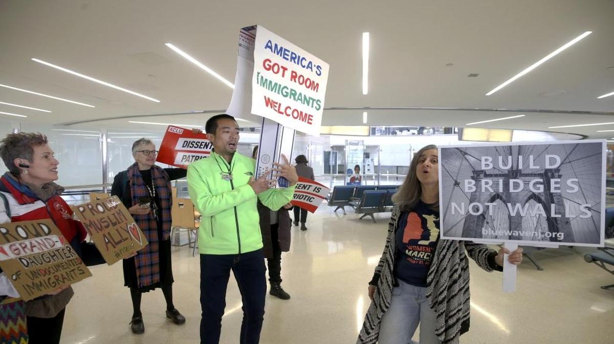 Protestors chant in Terminal B at the Newark International Airport prior to addressing the media, in Newark, NJ., Thursday March 16, 2017. A diverse group of advocates and immigrant New Jerseyans gathered to condemn Trump's updated travel ban.