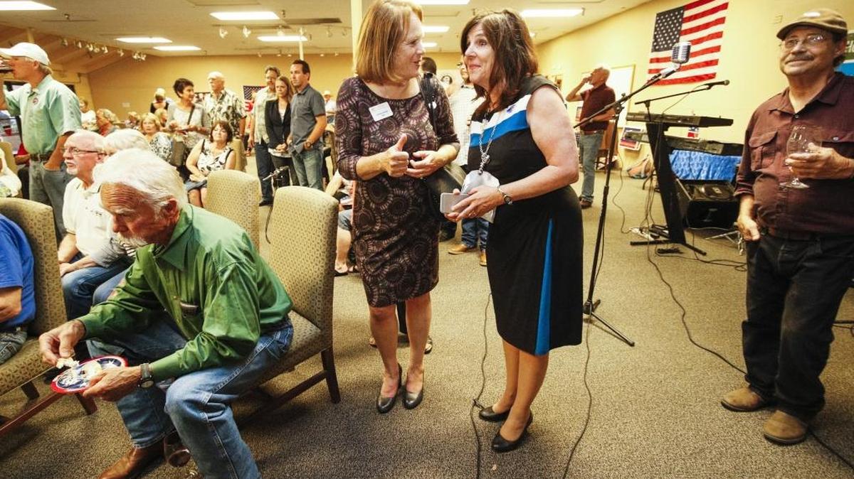 Debbie Arnold gets a thumbs up from supporter Corinne Kuhnle as they watch the initial results come in during Arnold’s election party in Atascadero.