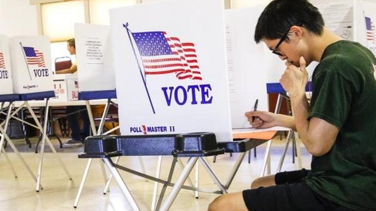 Christopher Chun casts his vote at the polls at the Zion Lutheran Church in San Luis Obispo.