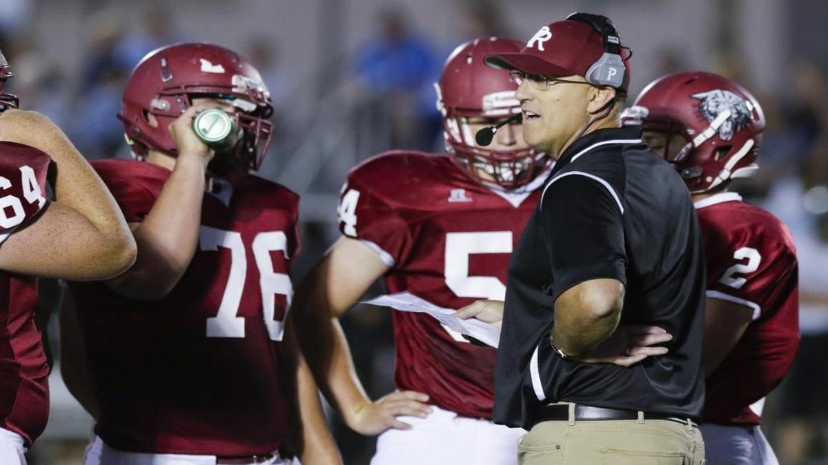 Rich Schimke speaks to Paso Robles High football players in a game against Clovis North in September.