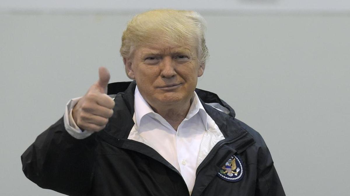 President Donald Trump gives a thumbs up after meeting people impacted by Hurricane Harvey during a visit to the NRG Center in Houston, Saturday, Sept. 2, 2017.