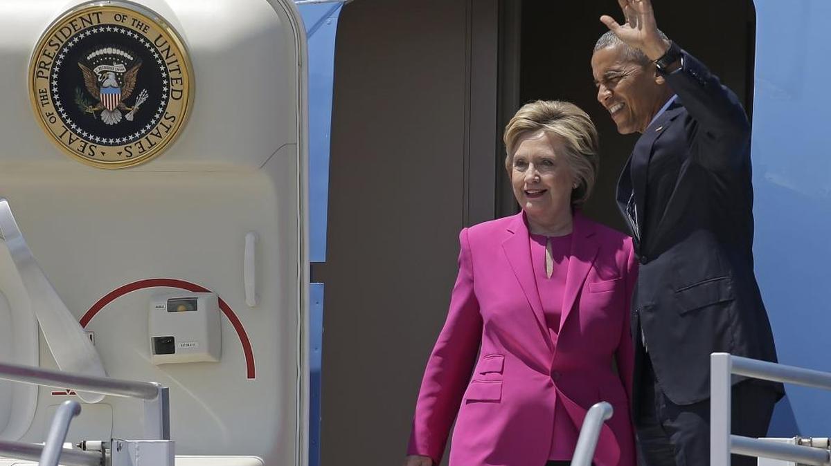 President Barack Obama waves as he and Democratic presidential candidate Hillary Clinton get off Air Force One in Charlotte, North Carolina, on Tuesday.