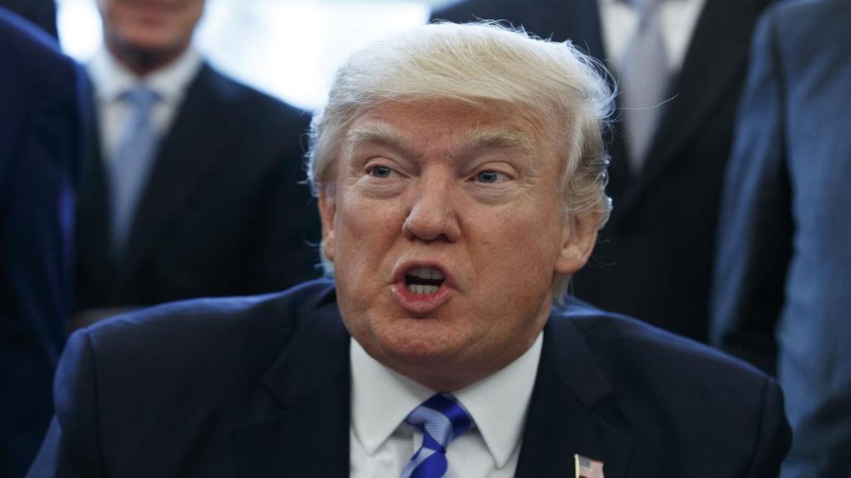 In a Friday, March 24, 2017 file photo, President Donald Trump announces the approval of a permit to build the Keystone XL pipeline in the Oval Office of the White House in Washington.