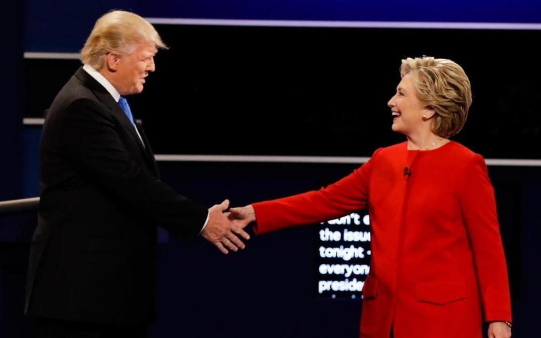 In this Sept. 26, 2016 file photo, Republican presidential nominee Donald Trump and Democratic presidential nominee Hillary Clinton shake hands during the presidential debate at Hofstra University in Hempstead, N.Y.