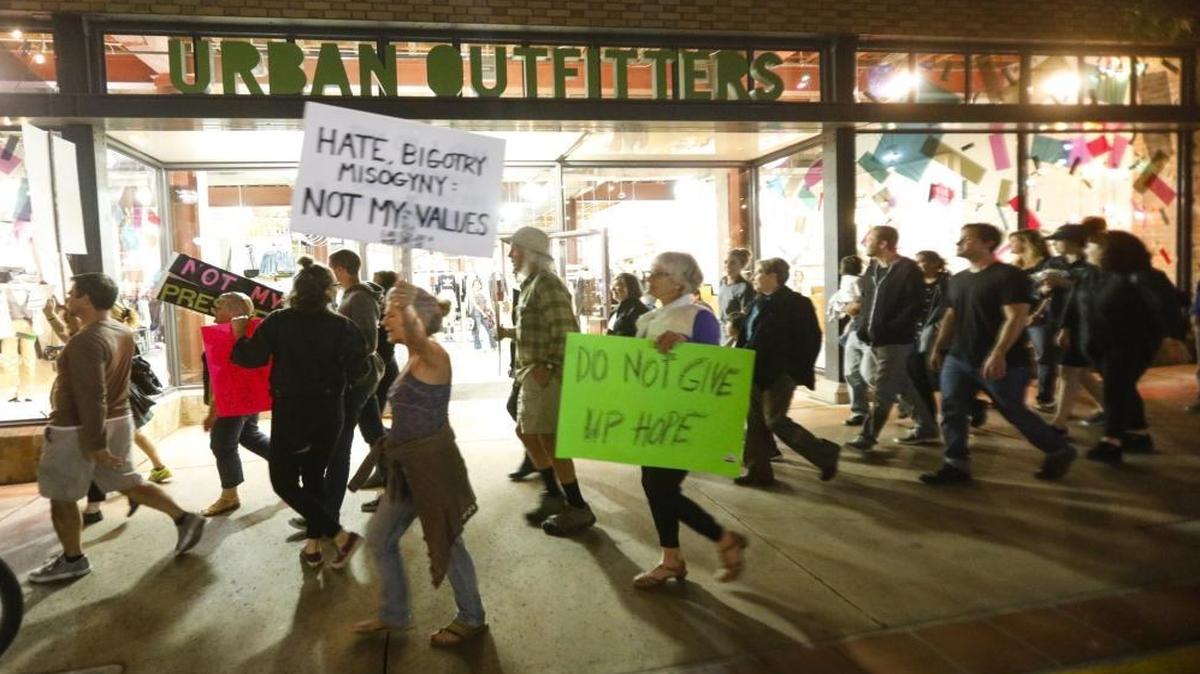 A protester holds a sign saying “Hate bigotry misogyny: not my values.” More than 200 sign-carrying protesters marched from the County Government Center to Farmer’s Market in protest of the election of Donald Trump on Nov. 10.