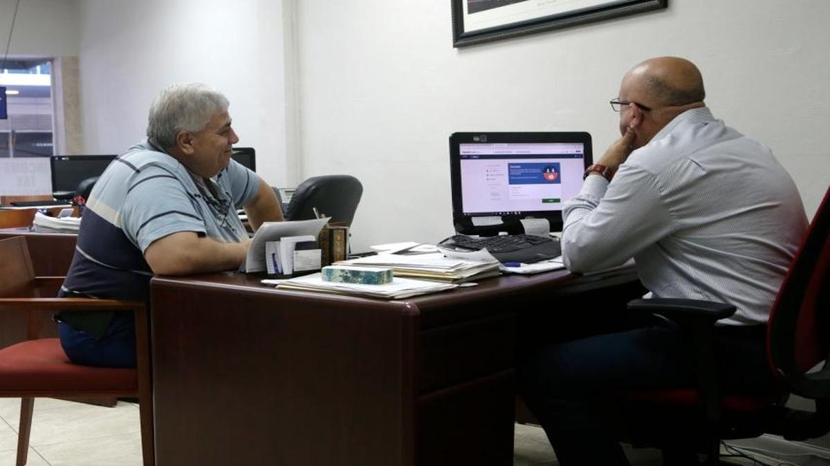A Miami resident signs up for health insurance offered under the Affordable Care Act with an insurance agent on Jan. 31, 2017, in Miami.