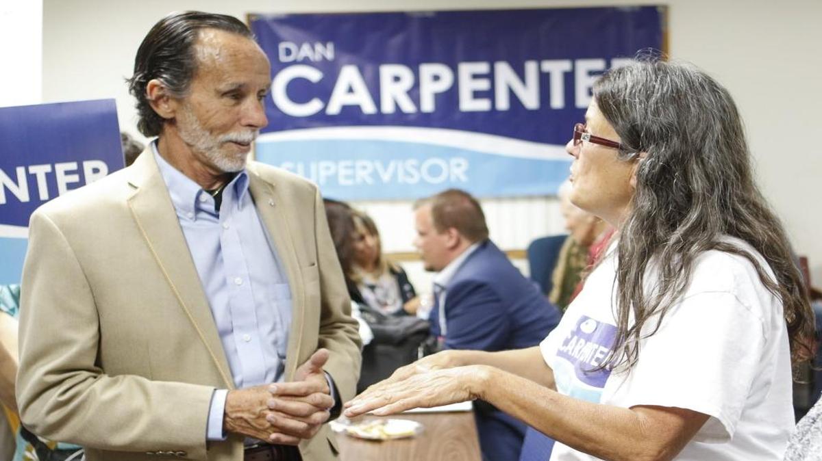 Dan Carpenter talks to supporter Patty Welsh on election night.