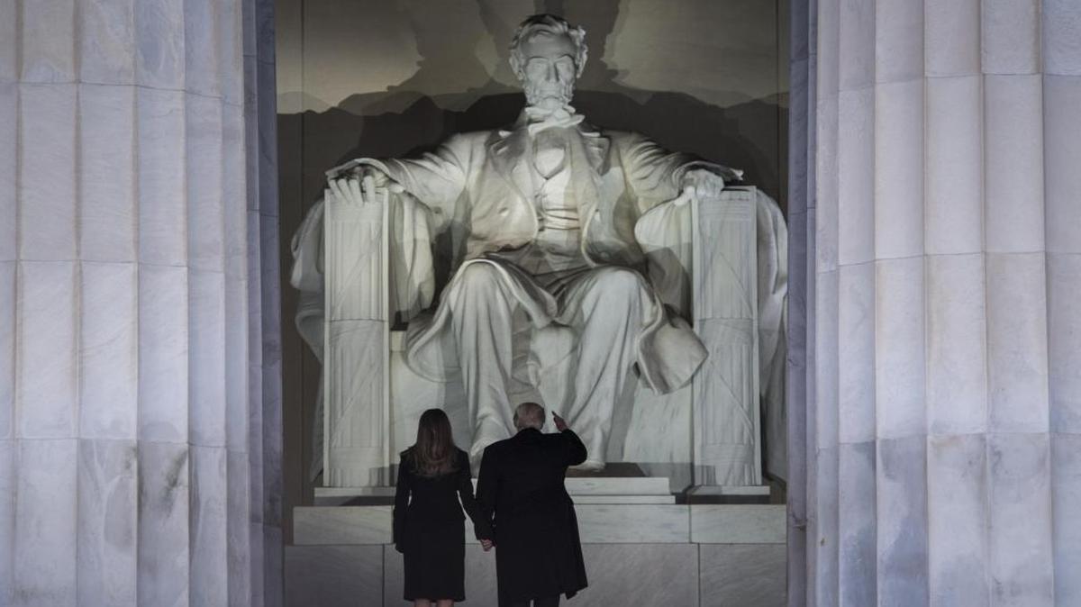 President Donald Trump and his wife, Melania Trump, stand before the Lincoln Memorial during the "Make America Great Again" concert Thursday as inauguration festivities got underway.