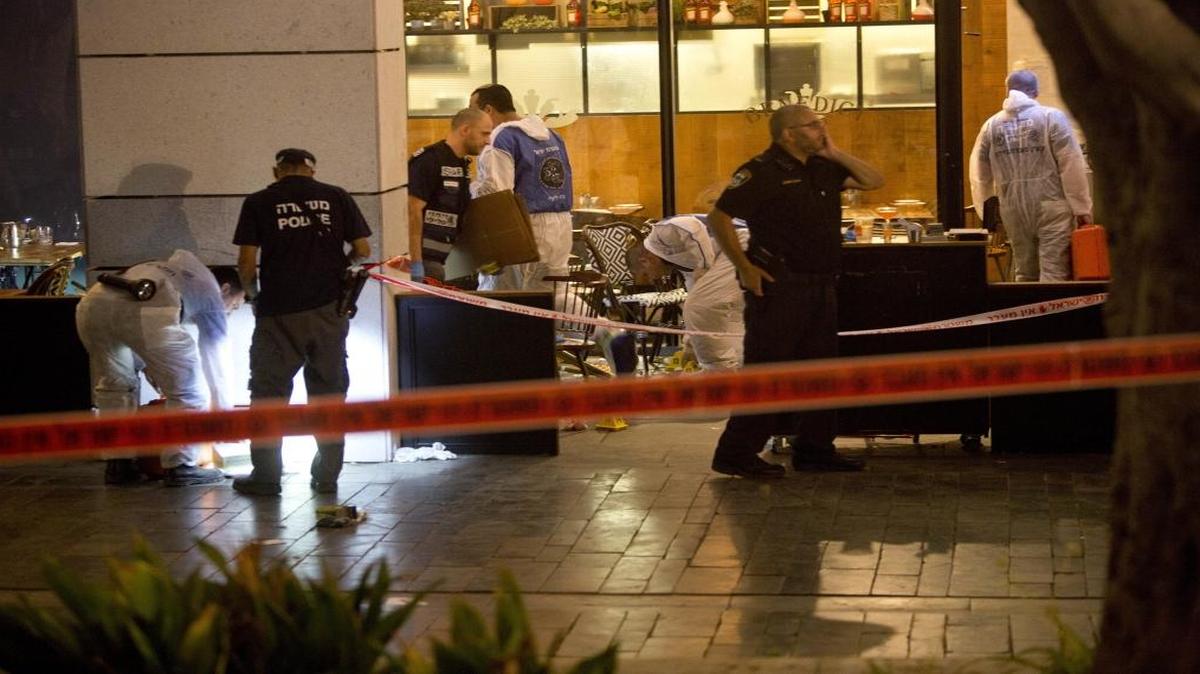 Israeli police officers examine the scene of a shooting attack in Tel Aviv, Israel, on Wednesday, June 8, 2016.