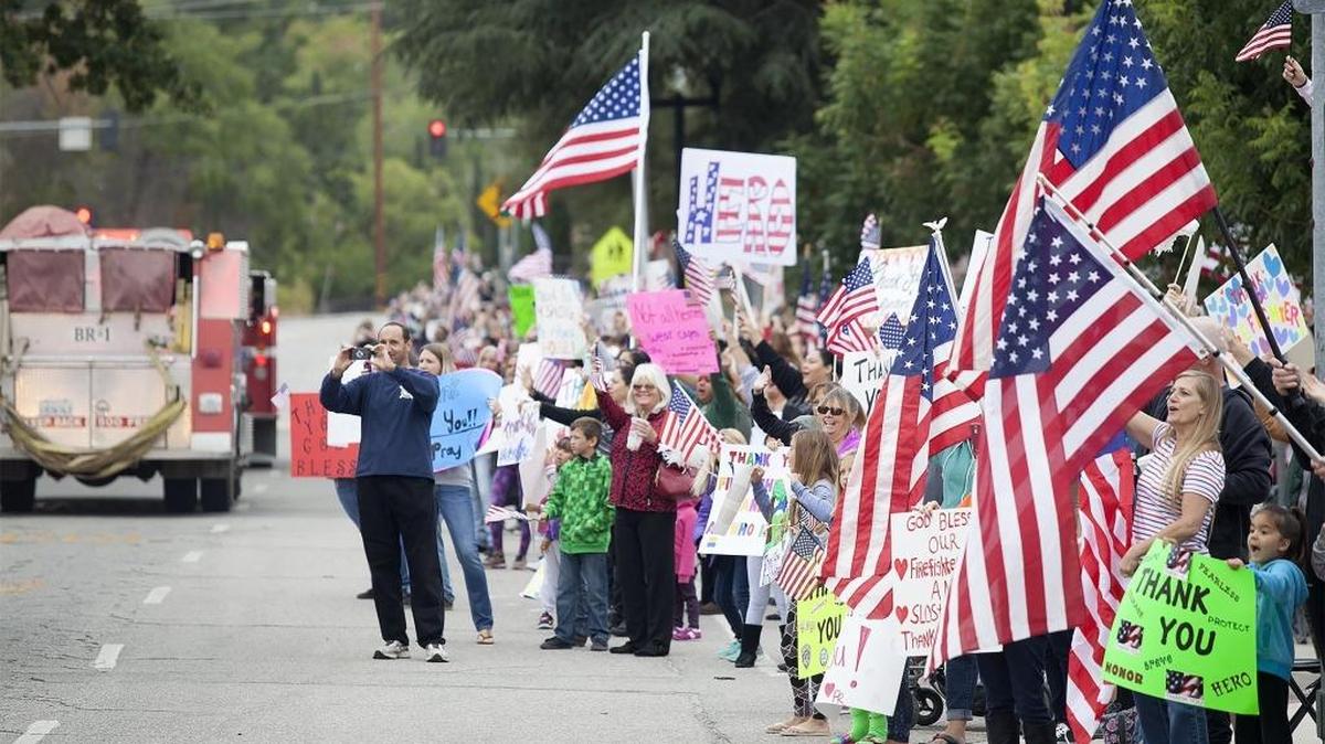 People gathered to cheer the firefighters on 24th Street in front of Rite Aid and Flamson Middle School on Aug. 27.
