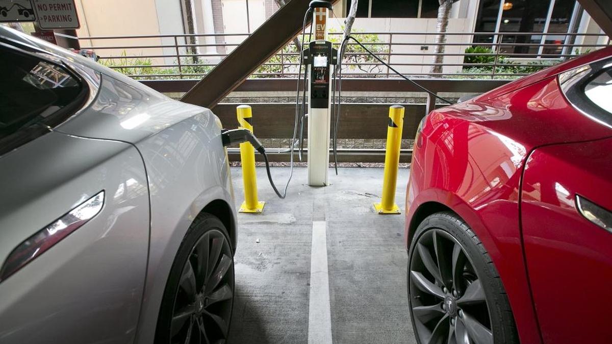 Two Tesla electric vehicles charge in Palo Alto on Nov. 5, 2015.
