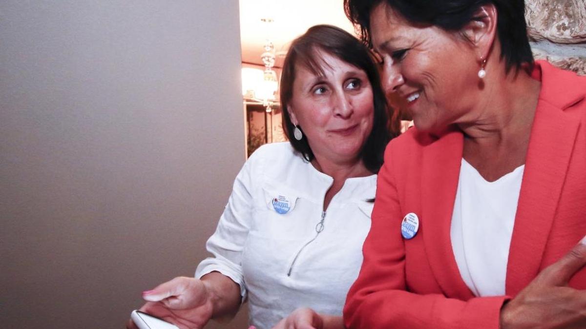 Maria Kelly, left, talks with Dawn Ortiz-Legg about election returns in June.