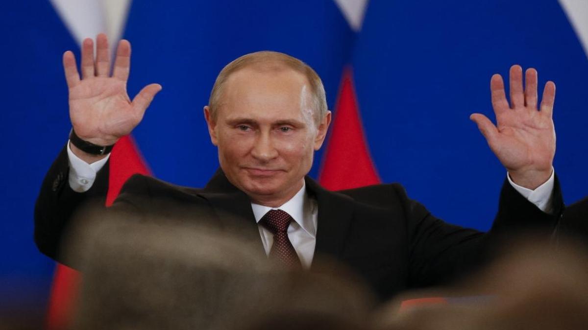 In this file photo taken on Tuesday, March 18, 2014, Russian President Vladimir Putin gestures after signing a treaty to incorporate Crimea into Russia in the Kremlin in Moscow, Russia.