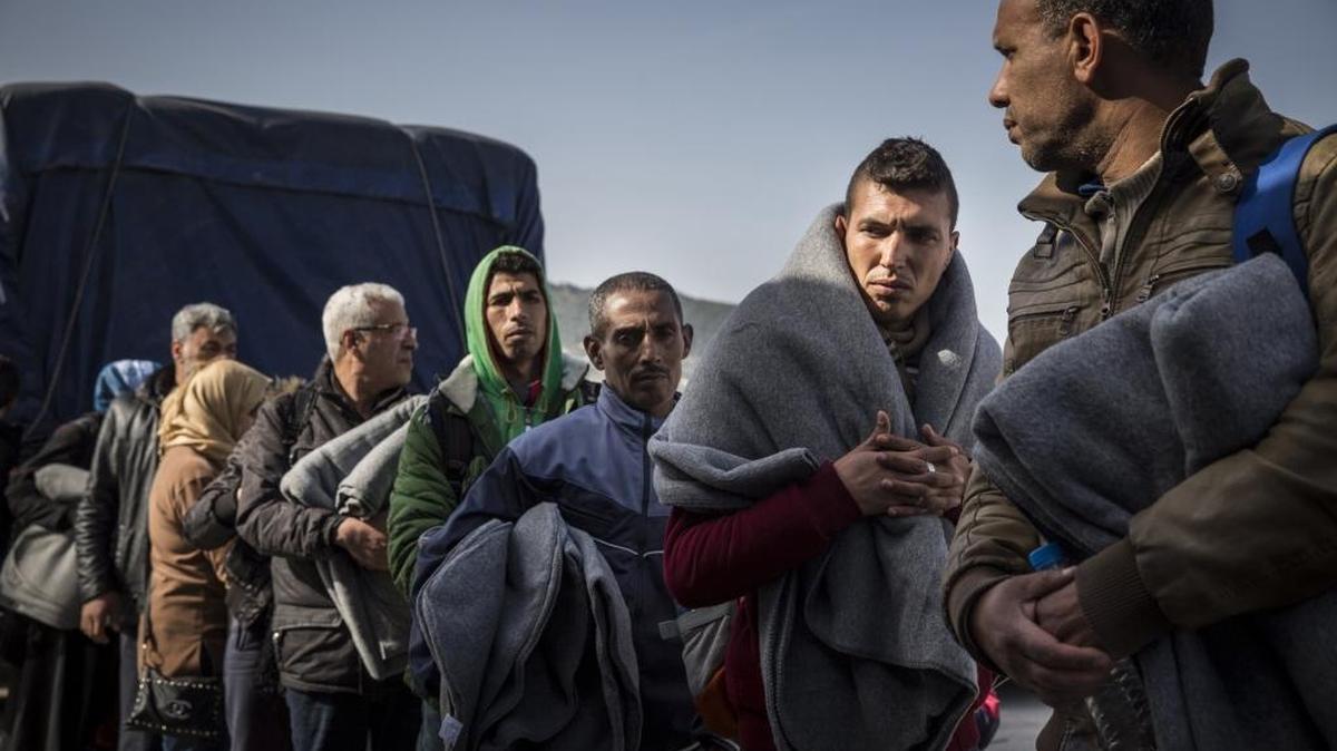 Migrants from Syria and Iraq line up for a bus carrying them to a detention center after arriving to the port of Mytilene on the first day of forced deportations to Turkey. Refugees continue to arrive on the Greek islands despite an EU/Turkey agreement allowing Greece to forcibly deport them back to Turkey.