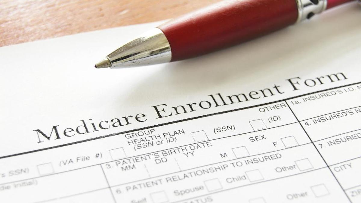 A closeup photo of a medicare enrollment form and pen.