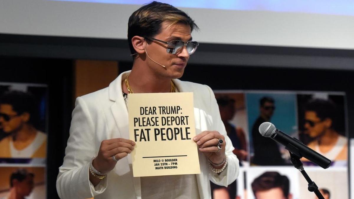 Milo Yiannopoulos holds a sign as he speaks at the University of Colorado campus in Boulder, Colo., on Wednesday, Jan. 25, 2017.