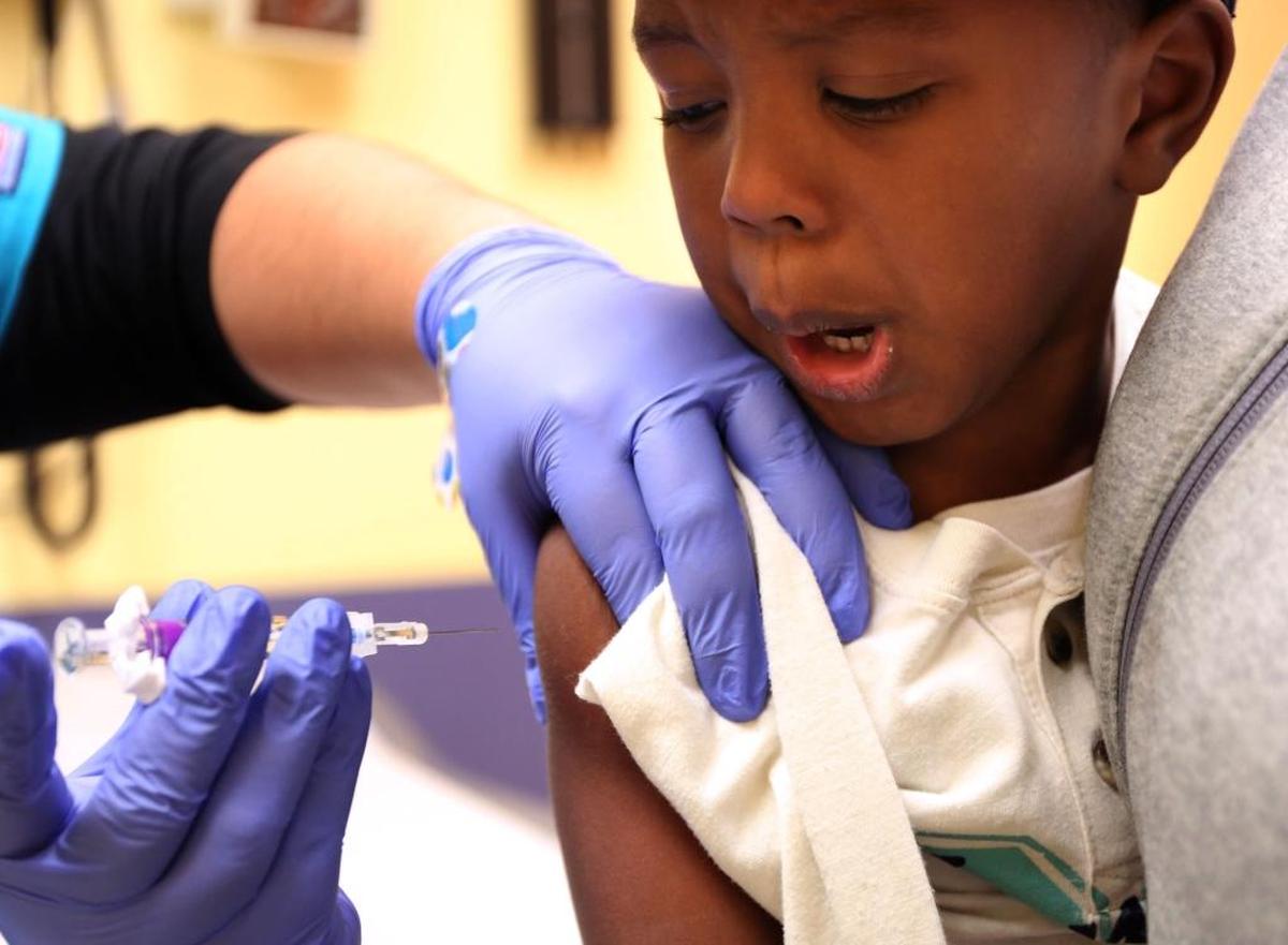 Kaiden Whittman, 3, receives a flu shot from medical assistant Gigi Hernandez at Advocate Children’s Hospital on Sept. 29. Children and their parents were not able to pick the needle-free nasal spray vaccine this year.