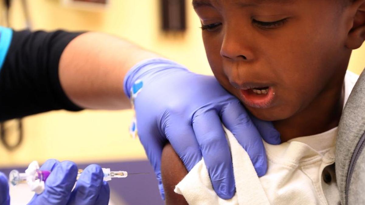 Kaiden Whittman, 3, receives a flu shot from medical assistant Gigi Hernandez at Advocate Children’s Hospital on Sept. 29. Children and their parents were not able to pick the needle-free nasal spray vaccine this year.