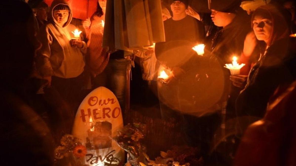 Mourners came out in the rain to attend a Friday night vigil in memory of David Fear, a Grover Beach man who suffered fatal injuries while trying to rescue his neighbor from a dog attack on Dec. 13. The sidewalk vigil was held on Nacimiento Avenue where Fear lived.